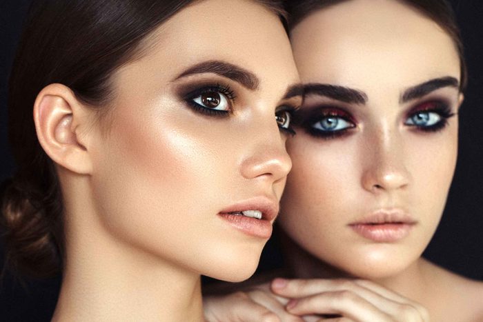 two dark-haired women with lots of eye makeup