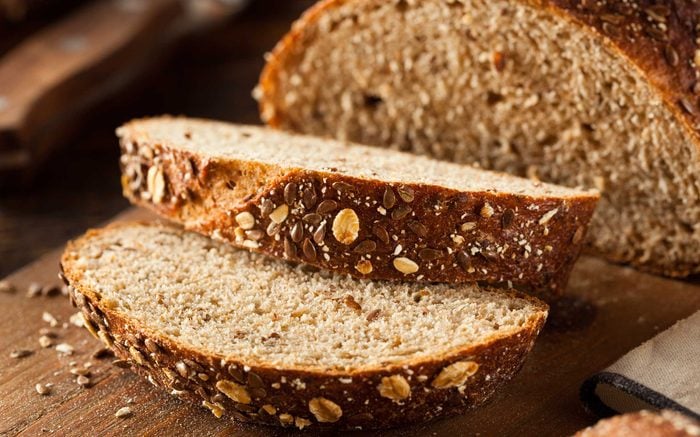 two slices cut from loaf of brown bread 