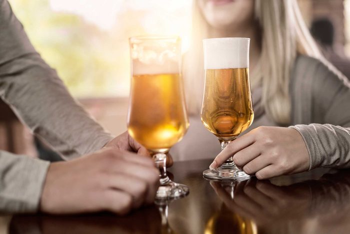 Man and woman drinking craft beer at a bar.