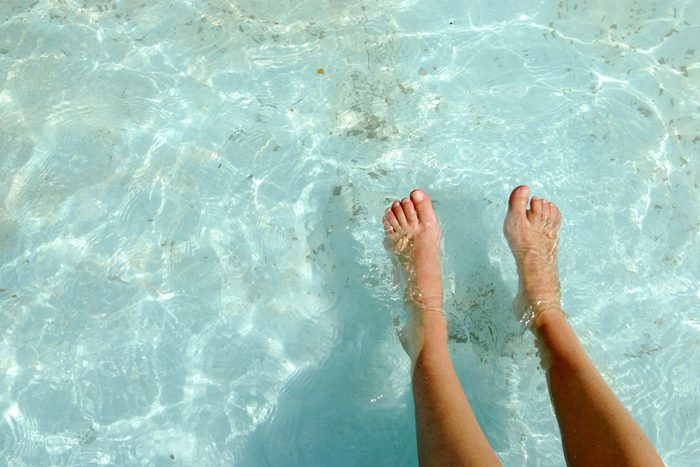 feet and legs in a pool