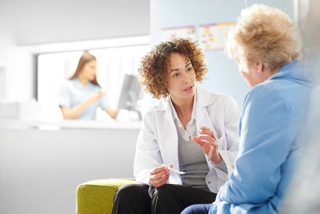 Female doctor talking to an elderly patient