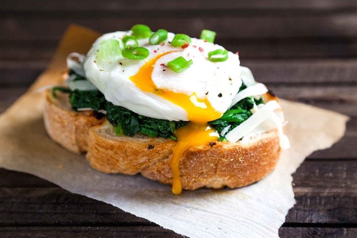 Toast with eggs, spinach, and green onions