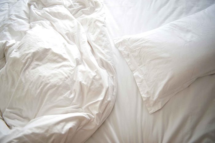 wrinkled white bedsheets
