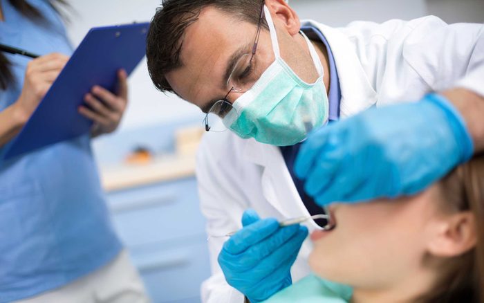 Dentist looking at patient's mouth
