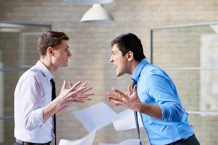 two men in shirts and ties arguing