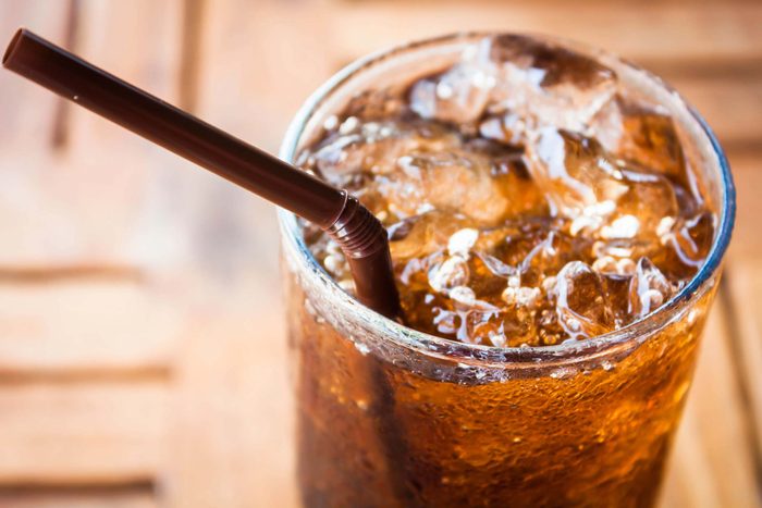 Glass of soda with ice and straw