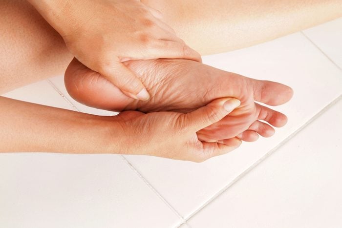 close up of person rubbing their foot