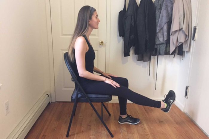 Woman doing seated ankle circle exercises.