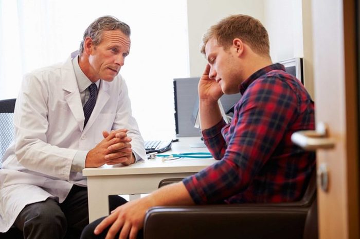 doctor explaining a diagnosis to a man in pain