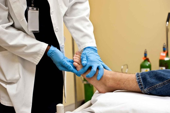 doctor checking patient's foot