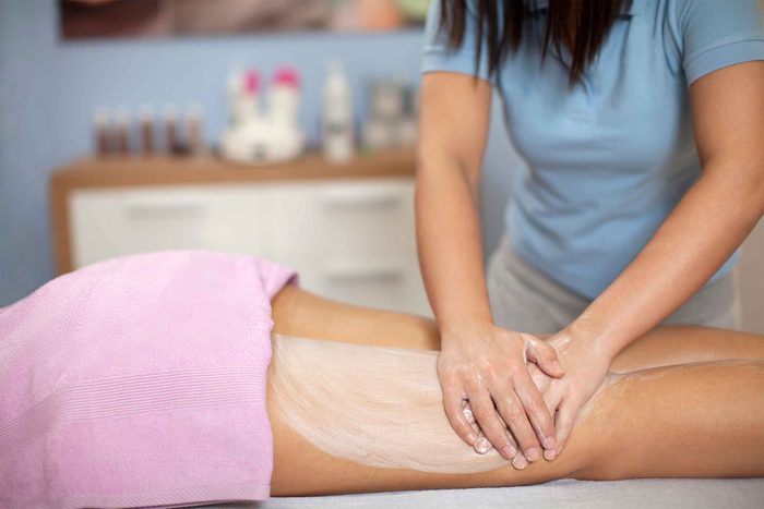 Woman giving a leg massage