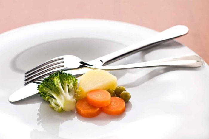 A plate with a very small portion of vegetables and nothing else