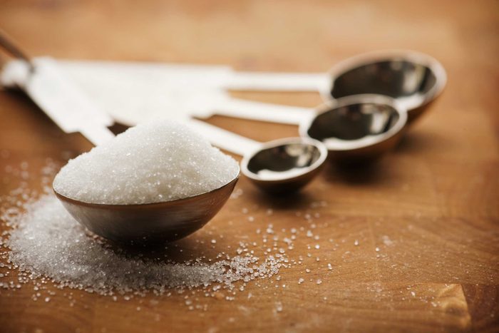 measuring spoons with tablespoon full of sugar