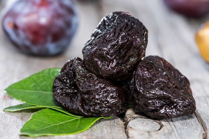 three prunes in front of a plum