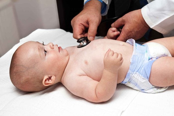 pediatrician with stethoscope on baby