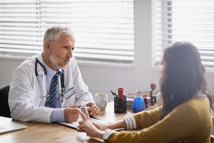 male doctor discussing diagnosis with female patient