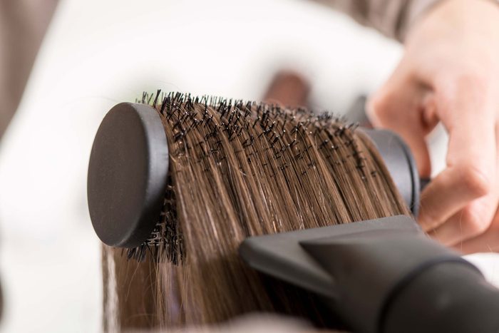 blowdrying hair in hair brush