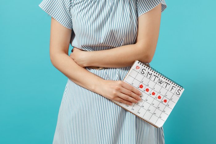 woman with calendar showing menstrual cycle
