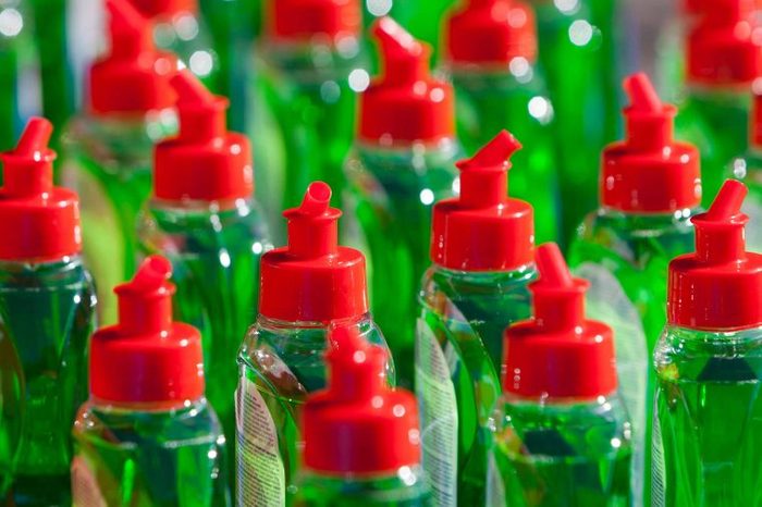 Array of green soap bottles with red caps