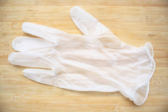 Clear latex glove on a wooden table.