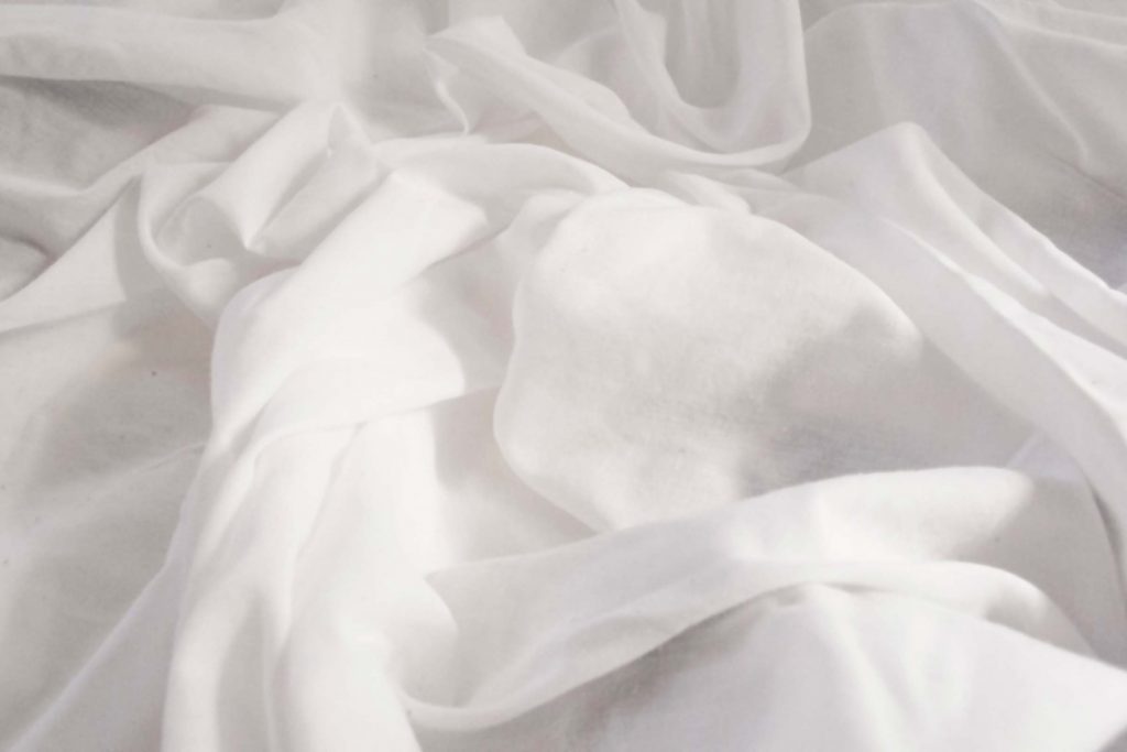 Billowy white bed sheets.