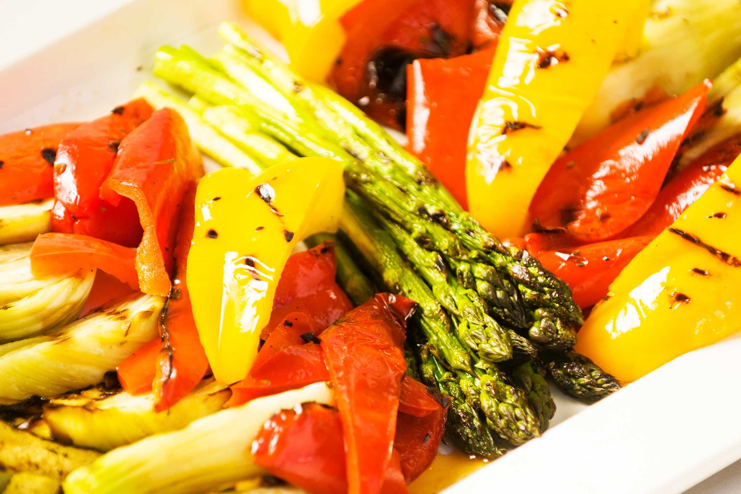 plate of cooked bell peppers, asparagus, and other vegetables