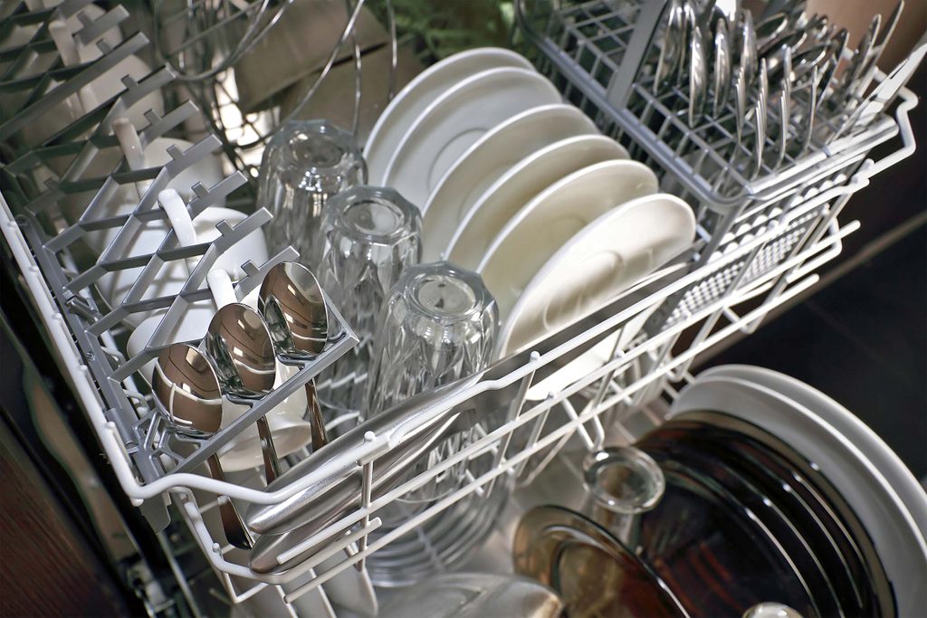 Clean dishes, glasses, and utensils in a dishwasher.