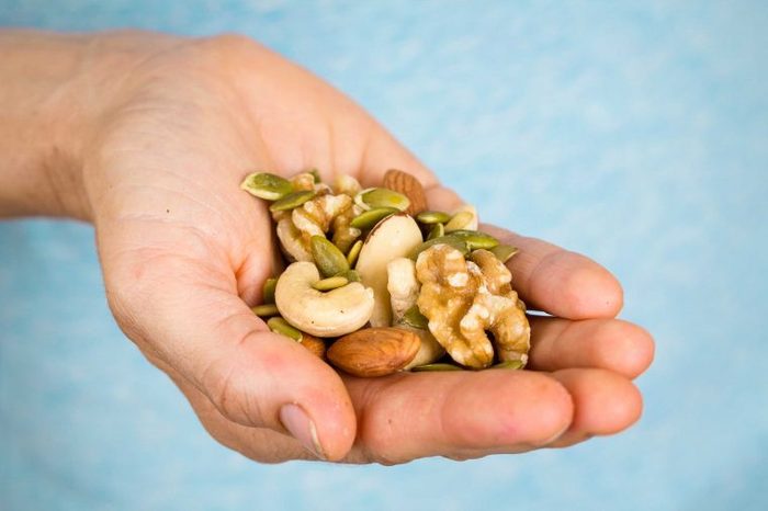 Handful of almonds, walnuts, and other nuts.