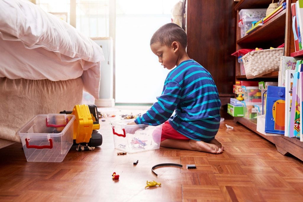 Young boy playing with toys.