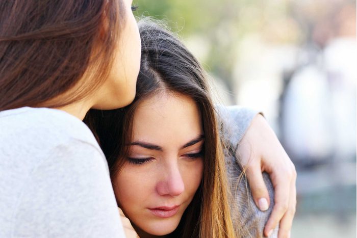 woman hugging and consoling upset woman