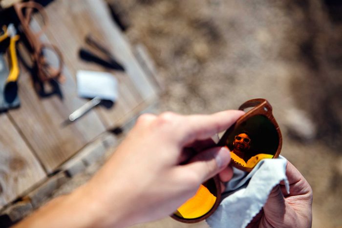 hands cleaning sunglasses