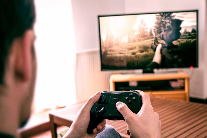 man playing a video game with controller in hand