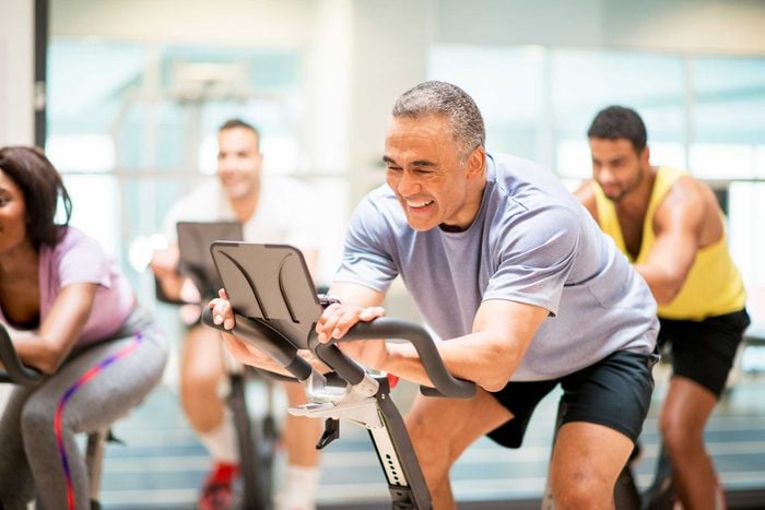 man in a spin class smiling