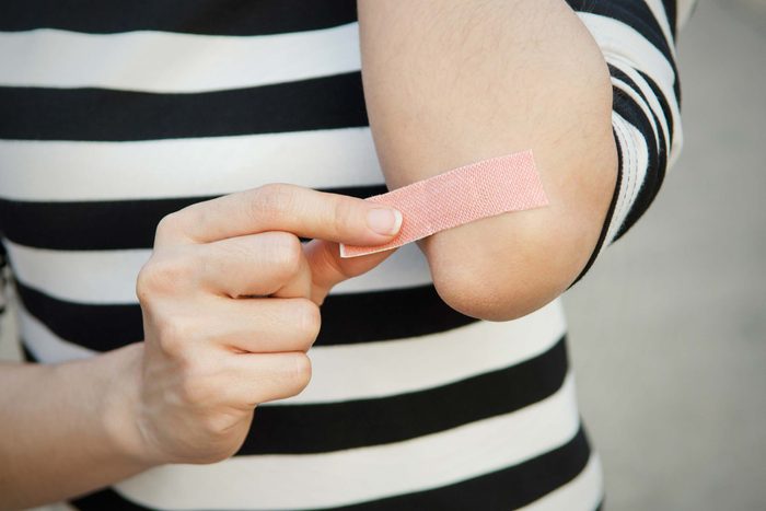 Person removing a band-aid