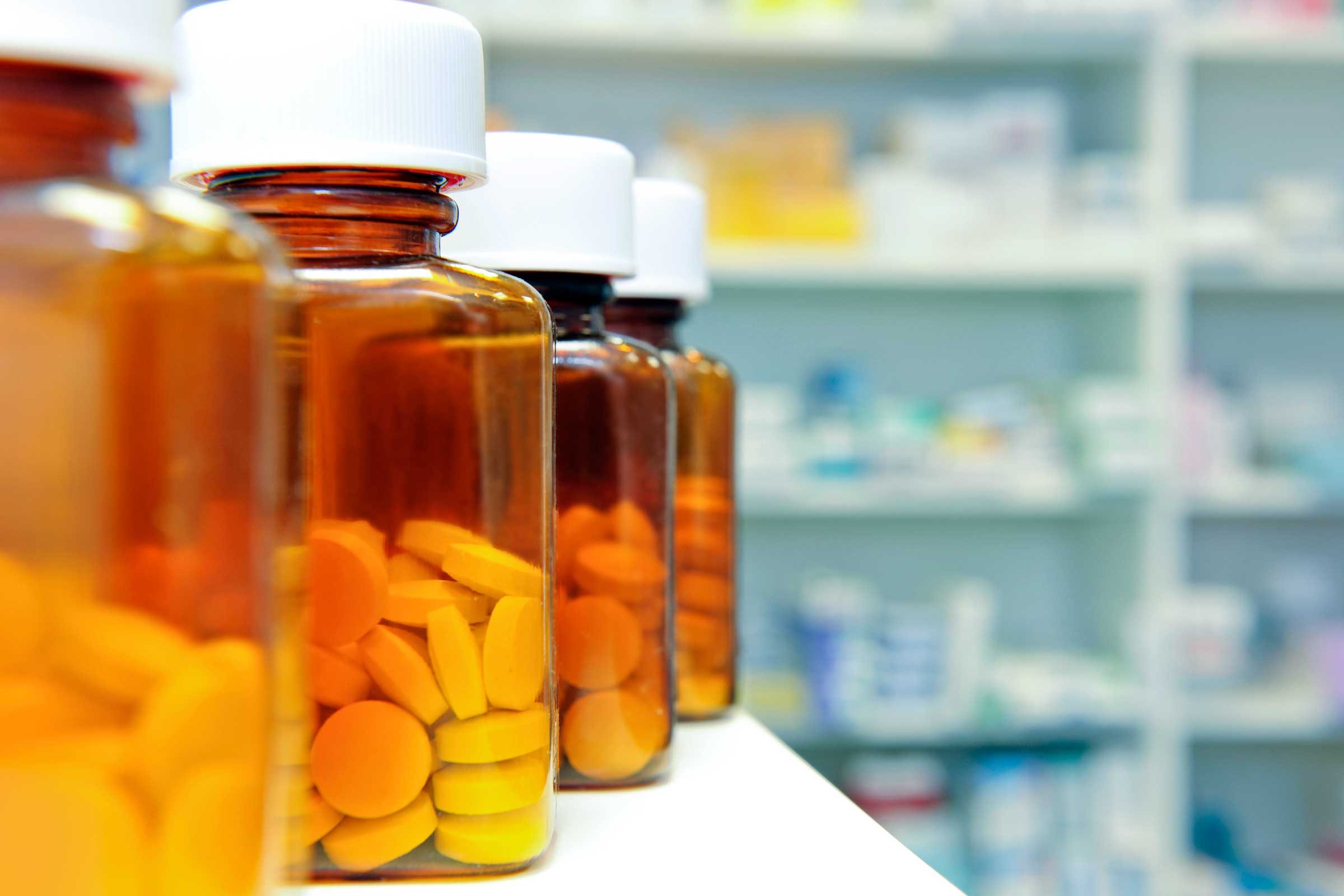 pill bottles on a pharmacy shelf