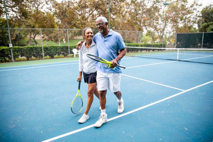 couple playing tennis together