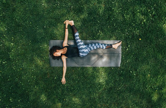overhead shot of woman doing yoga in the park