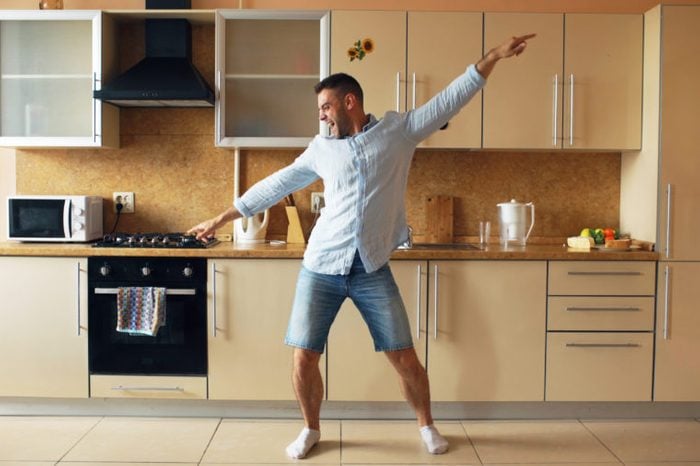 young man dancing in kitchen
