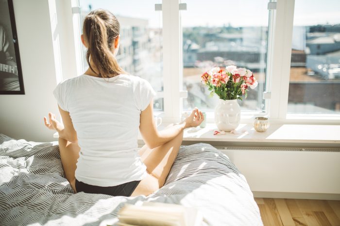 woman meditating in the morning to start the day
