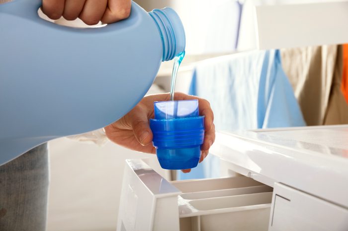 pouring laundry detergent