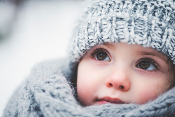 adorable toddler with crocheted hat and scarf 