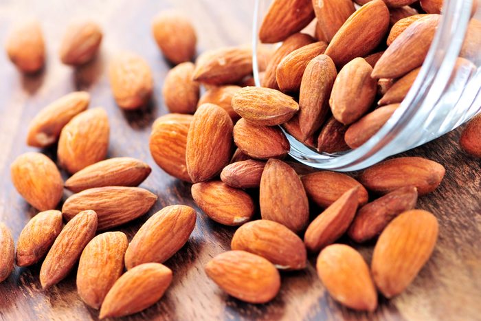 almonds spilling out of a glass dish