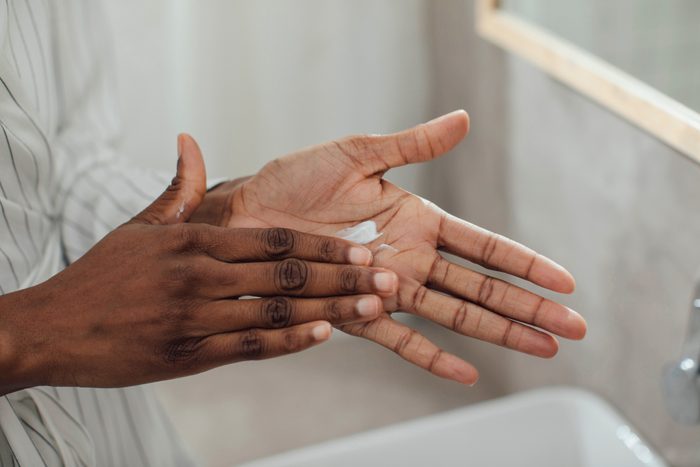 close up of woman moisturizing hands