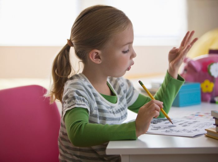 young girl doing math homework