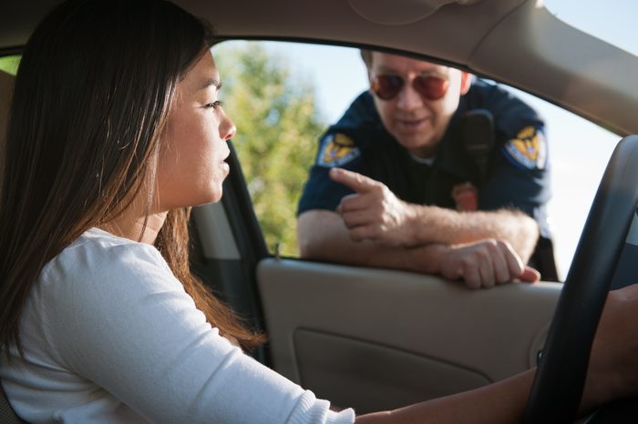 police officer talking to young woman pulled over