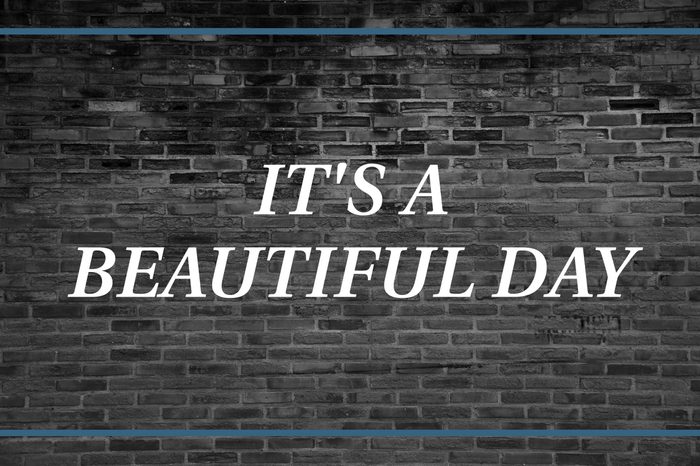 Brick wall background that says: It's a beautiful day.