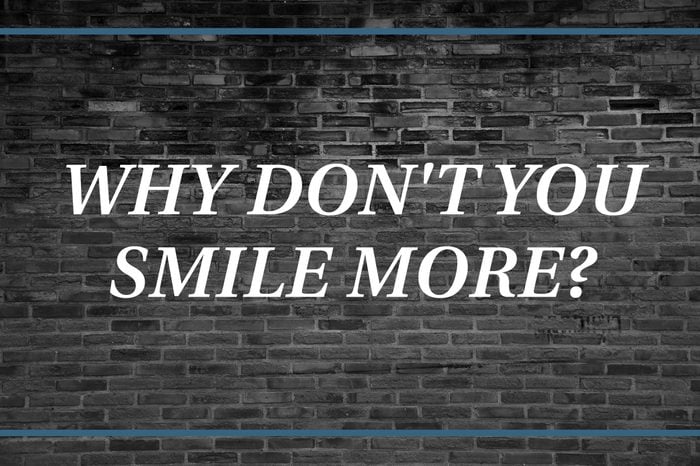 Brick wall background that says: Why don't you smile more?