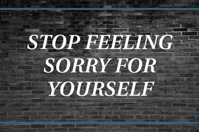 Brick wall background that says: Stop feeling sorry for yourself.