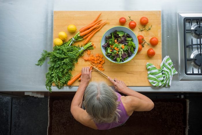 overhead view of woman making a healthy salad