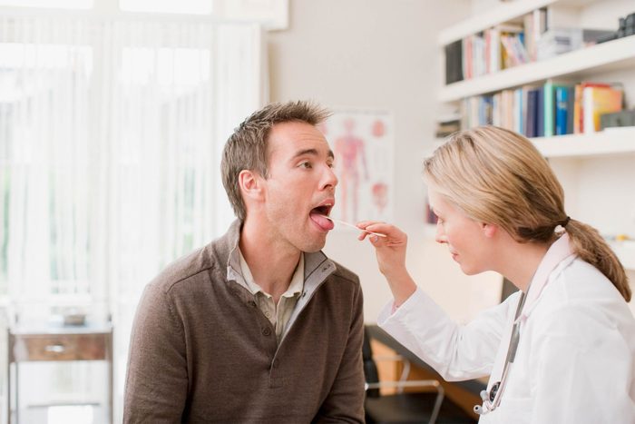doctor checking patient's mouth